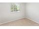 Neutral-toned bedroom featuring carpet and a large window, providing ample natural light at 7507 Holly Grove Ct, Charlotte, NC 28227