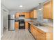 Functional kitchen featuring modern appliances, wood cabinetry, and ample counter space at 7507 Holly Grove Ct, Charlotte, NC 28227