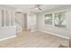 Bright living room with new flooring, stairway, large window, and neutral paint colors at 7507 Holly Grove Ct, Charlotte, NC 28227