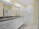 Elegant bathroom featuring double sink vanity, granite counters, and a glass-enclosed shower with built-in bench at 797 Latrobe Dr, Iron Station, NC 28080