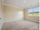 Bright bedroom with neutral carpet, a large window with backyard view, and neutral paint at 797 Latrobe Dr, Iron Station, NC 28080