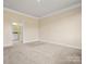 Large bedroom with carpeted floor and door open to the en-suite bathroom at 797 Latrobe Dr, Iron Station, NC 28080