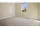 Cozy bedroom with plush carpet, a window offering natural light, and neutral paint at 797 Latrobe Dr, Iron Station, NC 28080