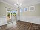 Bright dining room with slider to the backyard, wood floors, and wainscotting at 797 Latrobe Dr, Iron Station, NC 28080