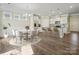 Dining room with modern chandelier, wood floors, and easy kitchen access at 797 Latrobe Dr, Iron Station, NC 28080