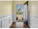 Inviting foyer with hardwood floors, white wainscoting, and a view to the outdoors through an open front door at 797 Latrobe Dr, Iron Station, NC 28080