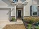 Inviting front entrance featuring a dark front door, stone accents, and a well-maintained walkway and manicured landscaping at 797 Latrobe Dr, Iron Station, NC 28080
