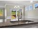 Close-up of granite countertops, stainless faucet and sink, windows and a sliding glass door at 797 Latrobe Dr, Iron Station, NC 28080