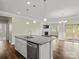 Spacious kitchen area featuring a center island with sink, granite countertops and an open view to the living room at 797 Latrobe Dr, Iron Station, NC 28080