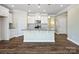 Modern kitchen featuring white cabinets, granite countertops, stainless steel appliances, and a center island with a sink at 797 Latrobe Dr, Iron Station, NC 28080