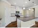 Modern kitchen featuring white cabinets, granite countertops, stainless steel appliances, and a center island with a sink at 797 Latrobe Dr, Iron Station, NC 28080