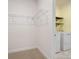 Functional laundry room featuring washer, dryer, wire shelving and wood accent shelves at 797 Latrobe Dr, Iron Station, NC 28080
