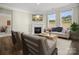 Cozy living room with fireplace, TV, couch, chairs, and large windows at 797 Latrobe Dr, Iron Station, NC 28080