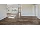 Open-concept living room features hardwood floors, a breakfast bar, and white cabinetry at 797 Latrobe Dr, Iron Station, NC 28080