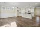 Bright living room features wood floors, recessed lighting, wainscotting, and a kitchen view at 797 Latrobe Dr, Iron Station, NC 28080