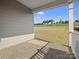 Inviting covered patio with an outdoor rug, overlooking a well-maintained lawn and blue skies at 797 Latrobe Dr, Iron Station, NC 28080