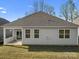 View of the back of the home featuring a well-kept lawn and patio area at 797 Latrobe Dr, Iron Station, NC 28080