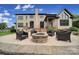 Beautiful brick patio with a stone fireplace and comfortable seating outside a cream brick home at 802 Capington Ln, Waxhaw, NC 28173