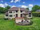 Expansive backyard features a brick patio with an outdoor fireplace perfect for entertaining, and lush landscaping at 802 Capington Ln, Waxhaw, NC 28173