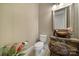 Stylish powder room with a decorative sink, elegant mirror, and floral accents at 802 Capington Ln, Waxhaw, NC 28173