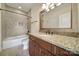 Well-appointed bathroom with granite countertops, traditional fixtures, and a tiled tub/shower combo at 802 Capington Ln, Waxhaw, NC 28173