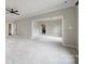 Large, open bonus room with neutral carpet and trim and multiple doorways at 802 Capington Ln, Waxhaw, NC 28173