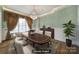 Elegant dining room with a chandelier, large table, and wainscoting at 802 Capington Ln, Waxhaw, NC 28173