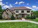Beautiful two-story home featuring stone accents, manicured landscaping, and a welcoming front entrance at 802 Capington Ln, Waxhaw, NC 28173