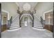 Grand foyer with a dual staircase, chandelier, and light tile flooring at 802 Capington Ln, Waxhaw, NC 28173