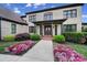 Elegant front entrance with a double door, covered porch, and blooming flower beds at 802 Capington Ln, Waxhaw, NC 28173