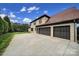 Spacious three-car garage and wide driveway provide ample parking on a well-manicured lot at 802 Capington Ln, Waxhaw, NC 28173