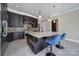 Stylish kitchen featuring a large island with seating, mosaic backsplash, and ample counter space at 802 Capington Ln, Waxhaw, NC 28173