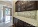 Elegant pantry with dark wood cabinets, granite countertops, and mosaic backsplash at 802 Capington Ln, Waxhaw, NC 28173