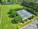 Aerial shot of well-maintained tennis courts surrounded by lush landscaping and manicured lawns at 802 Capington Ln, Waxhaw, NC 28173