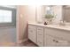 Bathroom featuring a double vanity with gray countertops and an adjacent bedroom at 8065 Cornhill Ave, Charlotte, NC 28277