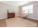 Cozy bedroom with natural light and wood floor, perfect for relaxing or as a home office at 8065 Cornhill Ave, Charlotte, NC 28277