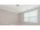 Bedroom with carpet flooring, neutral walls, and a large window with white blinds at 8065 Cornhill Ave, Charlotte, NC 28277