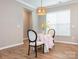 Cozy breakfast nook featuring table set for two with a wicker pendant light fixture above at 8065 Cornhill Ave, Charlotte, NC 28277