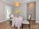 Charming breakfast nook with table set for two near a bright, light-filled door leading outside at 8065 Cornhill Ave, Charlotte, NC 28277
