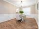 Bright dining room with hardwood floors and decorative wainscoting provides an elegant space for meals at 8065 Cornhill Ave, Charlotte, NC 28277