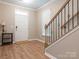 Welcoming entryway with wood-look floors and classic staircase, perfect for inviting guests at 8065 Cornhill Ave, Charlotte, NC 28277