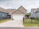 Well-maintained home exterior featuring a two-car garage and a fenced yard at 8065 Cornhill Ave, Charlotte, NC 28277