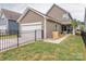 Lovely home exterior with fenced yard, attached garage, and a cozy outdoor patio area at 8065 Cornhill Ave, Charlotte, NC 28277