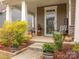 Inviting front porch with stylish chairs, plants, and decorative accents at 8065 Cornhill Ave, Charlotte, NC 28277