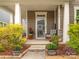 Charming front porch with stylish chairs and decorative accents and planters at 8065 Cornhill Ave, Charlotte, NC 28277