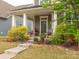 Inviting front porch with landscaping, decorative plants, and charming seating area at 8065 Cornhill Ave, Charlotte, NC 28277
