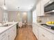 Modern kitchen featuring stainless appliances, quartz countertops, and adjacent breakfast area with ample natural light at 8065 Cornhill Ave, Charlotte, NC 28277