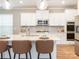 Modern kitchen island with pendant lighting, granite countertops, and stainless steel appliances at 8065 Cornhill Ave, Charlotte, NC 28277