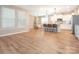 Open-concept living space with a kitchen, breakfast nook, large windows, and hardwood flooring throughout at 8065 Cornhill Ave, Charlotte, NC 28277