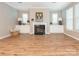 Spacious living room features a fireplace, hardwood floors, and built-in cabinets at 8065 Cornhill Ave, Charlotte, NC 28277